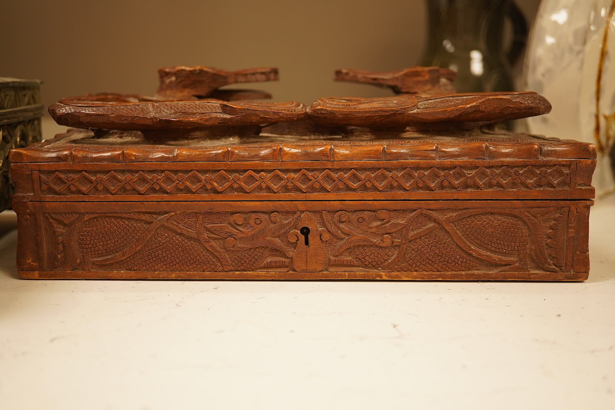 A late 19th century Japanese gilt metal lidded box together with a Burmese carved hardwood box, 28cm wide